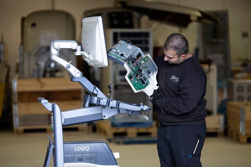 Technician harvesting parts